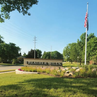 Exterior sign of Heather Hills facility with landscaping