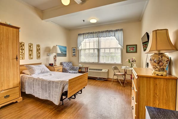 Interior view of a resident's room with a bed and furniture