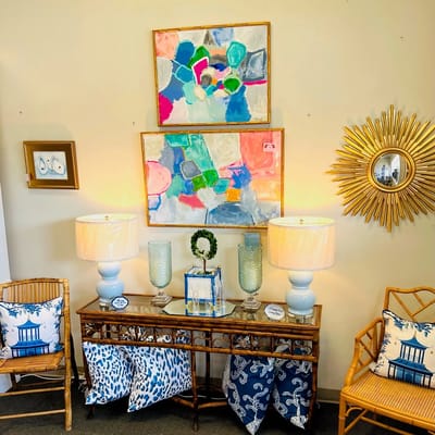 Brightly colored abstract paintings and decorative furniture in a living room setting.