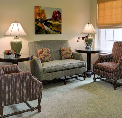 Comfortable seating area with decorative lamps and artwork