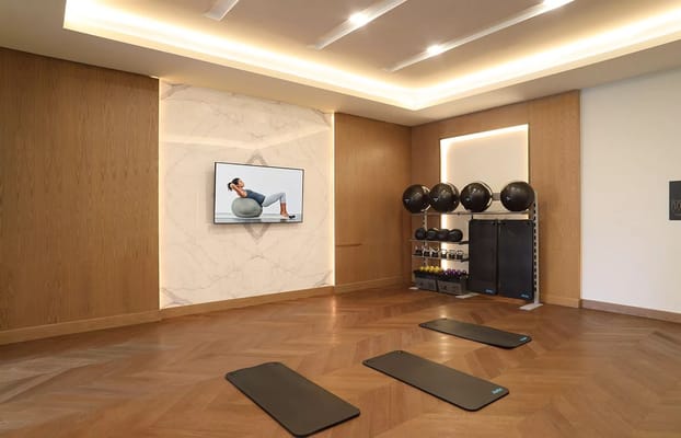 Well-equipped fitness room with exercise mats and equipment