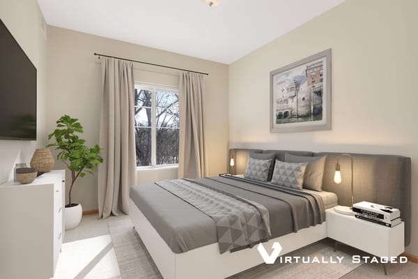 Modern bedroom with gray decor and a large window