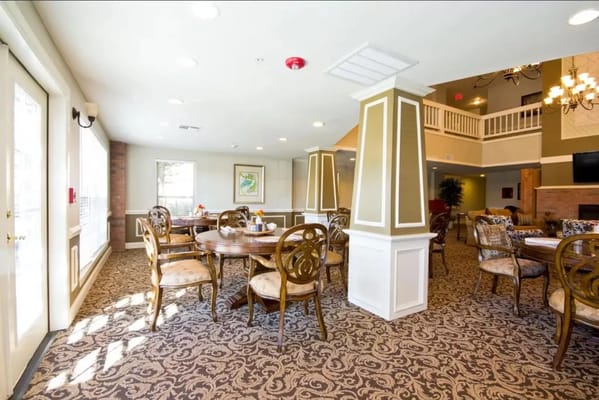Bright dining area with wooden tables and decorative chairs