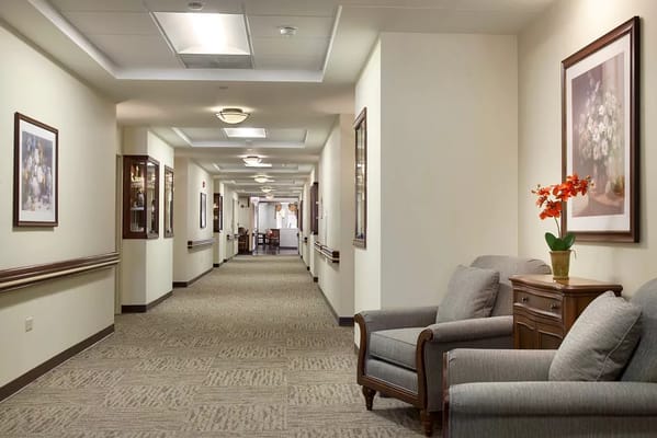 A well-lit corridor in a senior living facility