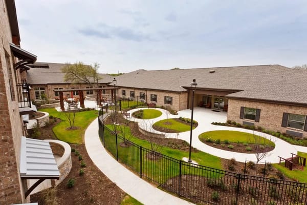 Aerial view of a landscaped courtyard with walking paths and seating areas.