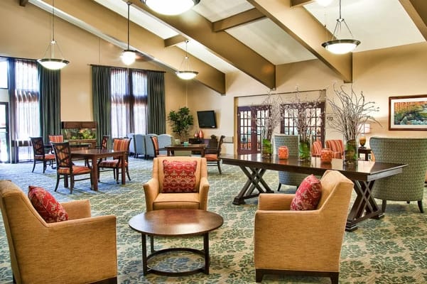 Spacious lounge area with comfortable seating and tables