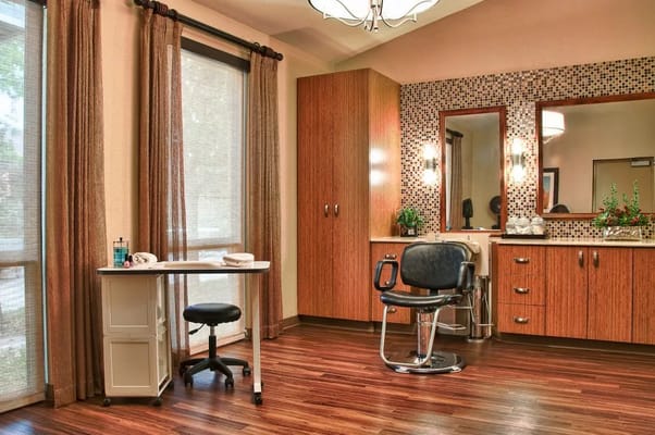 Inside view of a hair salon with styling chair and mirrors