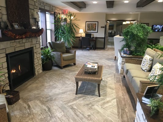 Warm, inviting common area with seating and a fireplace