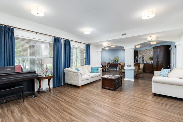 Cozy living room with light beige sofa and blue curtains