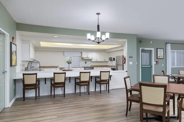 Modern kitchen and dining area with tables and chairs