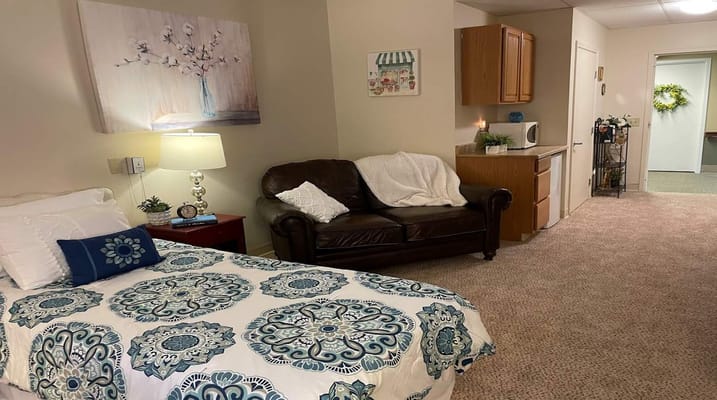 Cozy resident room with a bed and seating area