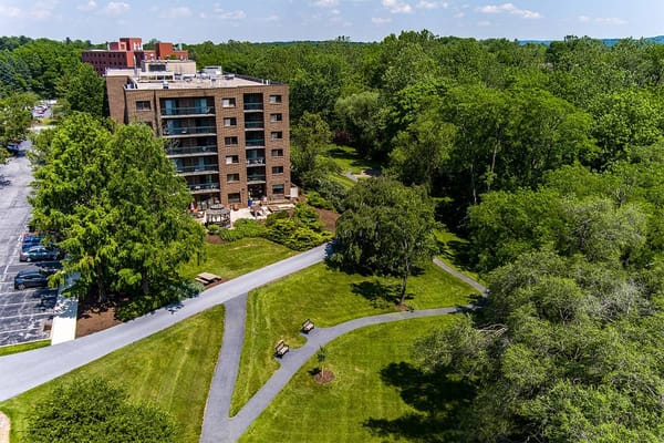 Aerial view of a senior living facility surrounded by greenery