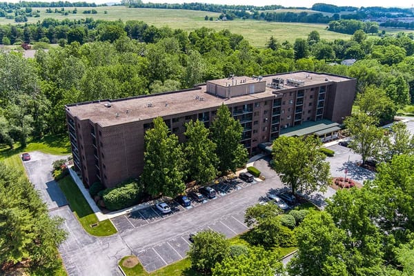 Aerial view of The Woods at Cedar Run facility surrounded by greenery