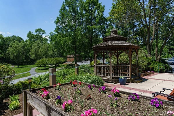 A garden area with flowers and a gazebo