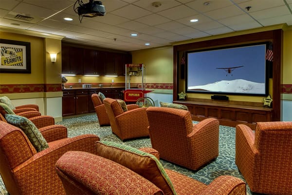 Comfortable seating in a common area with a large screen