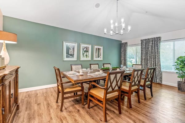 Well-appointed dining room with a large table and decorative wall art