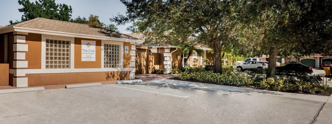 Front entrance of The Club At Wellington with parking area