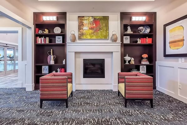 Cozy lounge area with striped chairs and a fireplace