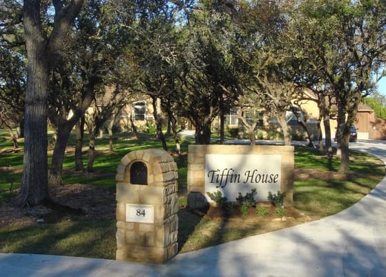 Entrance sign of Tiffin House with stone mailbox.