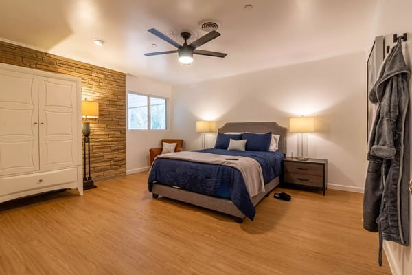 A cozy bedroom with modern furnishings and warm lighting