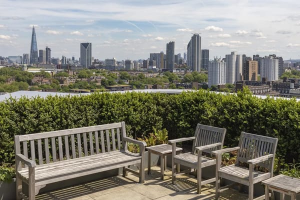 Seating area with view of London skyline from Tonic Housing rooftop