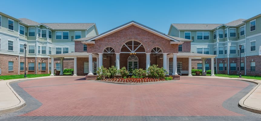 Main entrance of Town Village Retirement Community featuring a landscaped driveway.