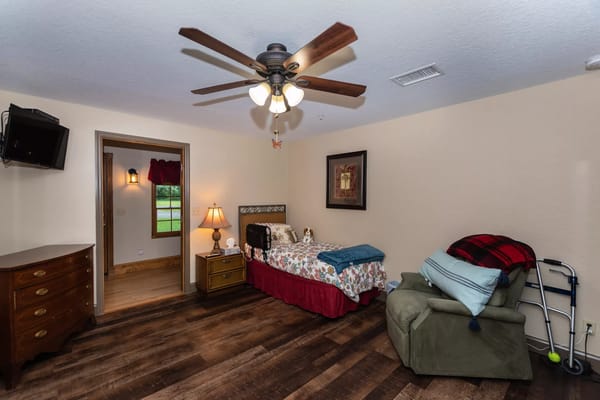 Bedroom with bed, dresser, and seating area