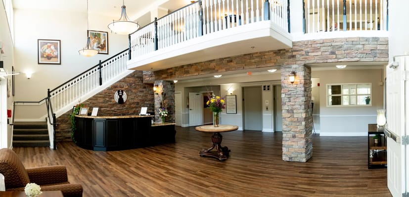 Spacious lobby with a reception desk and staircase