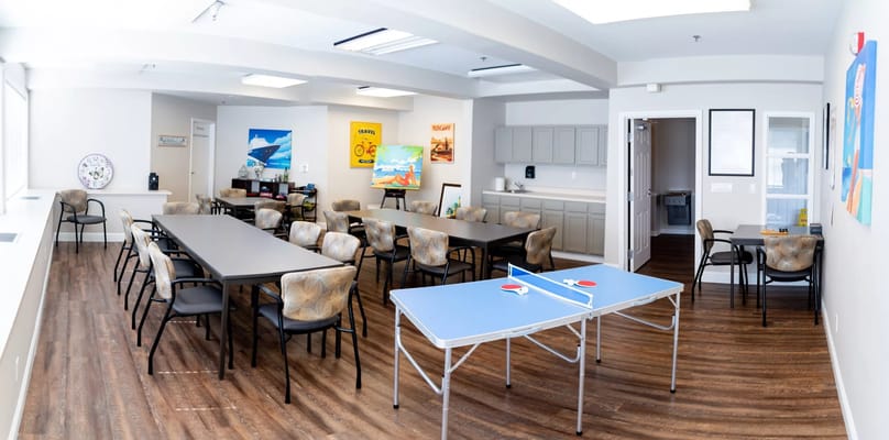 Shared activity space with tables and chairs at TreVista Senior Living