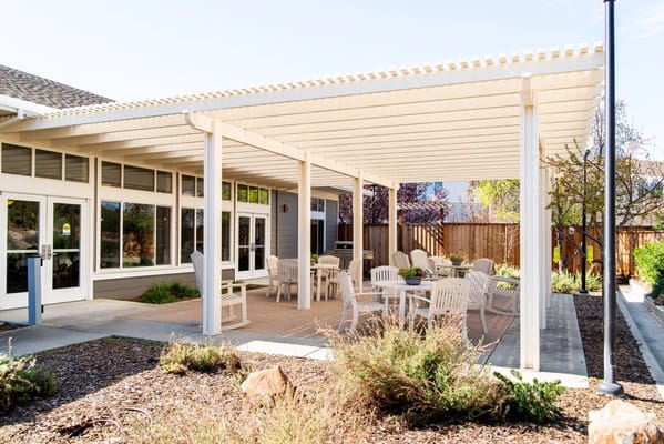 Outdoor patio with tables and chairs at TreVista Senior Living