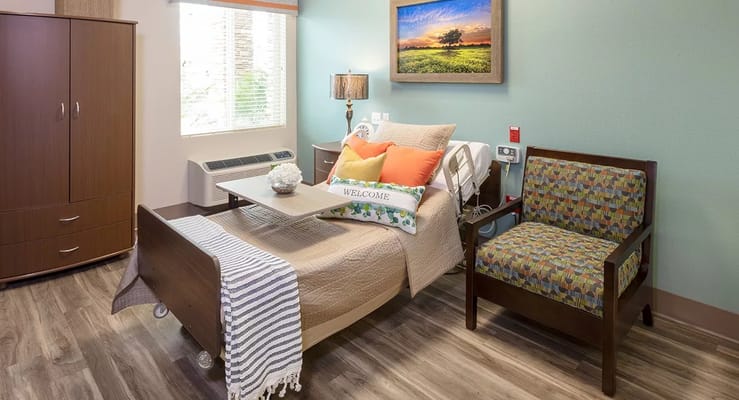 Cozy bedroom featuring a bed, side table, and seating area