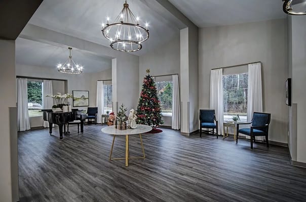 Holiday-decorated lobby with a grand piano and festive tree