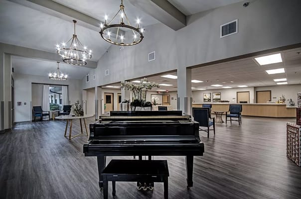 Lobby area featuring a grand piano and light fixtures.