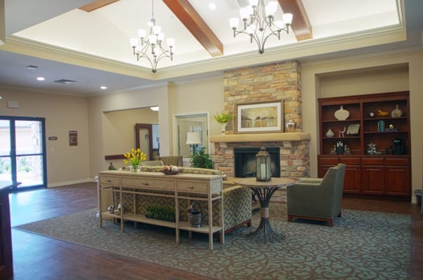 Cozy lobby with seating, a fireplace, and decorative elements.