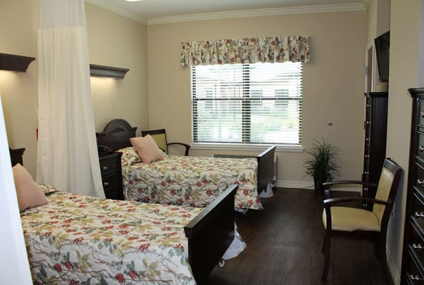 Shared bedroom with two beds and a sunny window