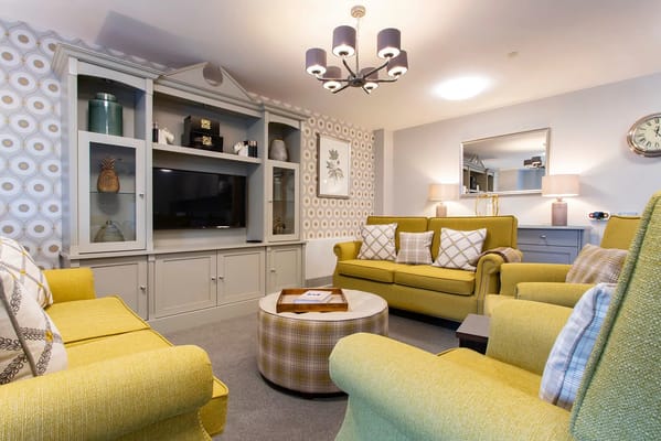 Bright interior common area with yellow chairs and decor