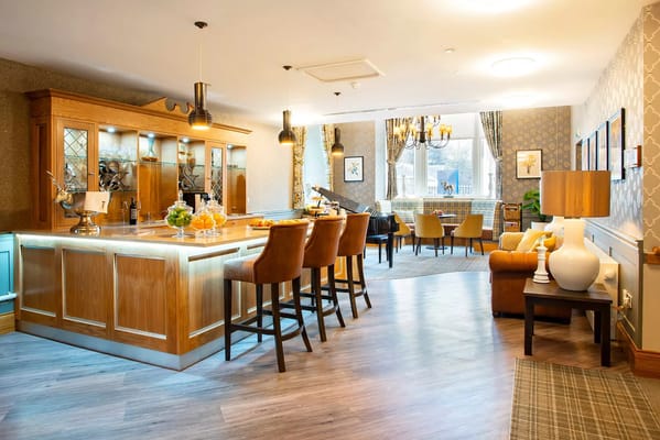 Bright common area with seating and a bar