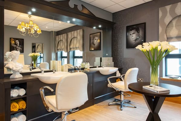 Beauty salon area with styling chairs and decor