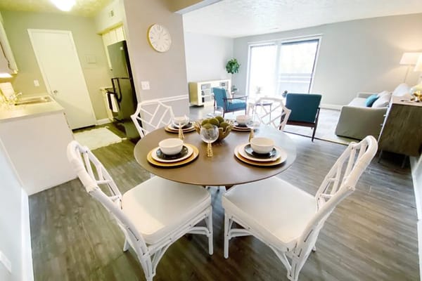 Cozy dining table set with white chairs and tableware