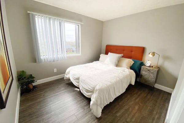 Bright bedroom featuring a double bed and large window