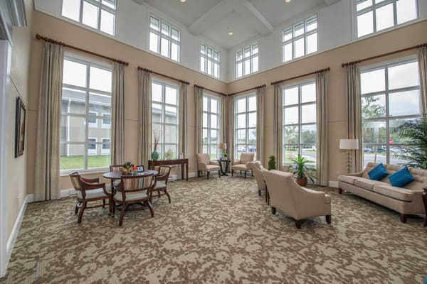 Bright common area with seating and large windows