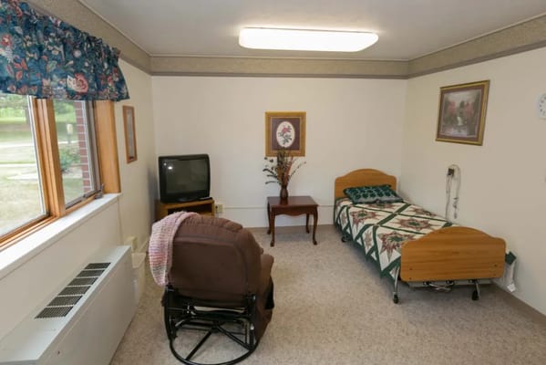 Private resident room with bed and seating area