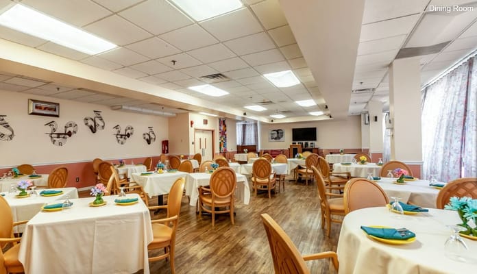 Brightly decorated dining room with tables set for meals.