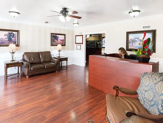Reception area with seating and a staff member