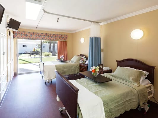 Bright shared bedroom with two beds and flowers