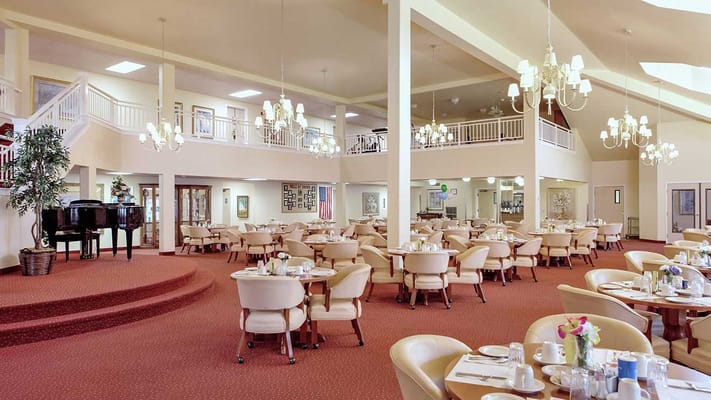 Spacious dining area with tables and chairs at University Pines