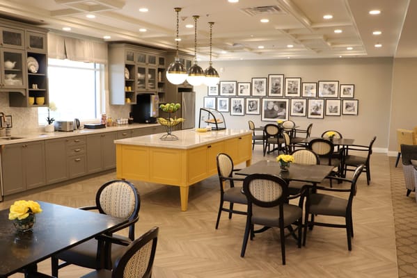 Bright dining room with yellow accents and framed photos
