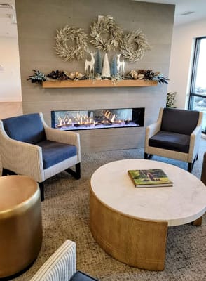 A stylish living room featuring a modern fireplace and comfortable seating.