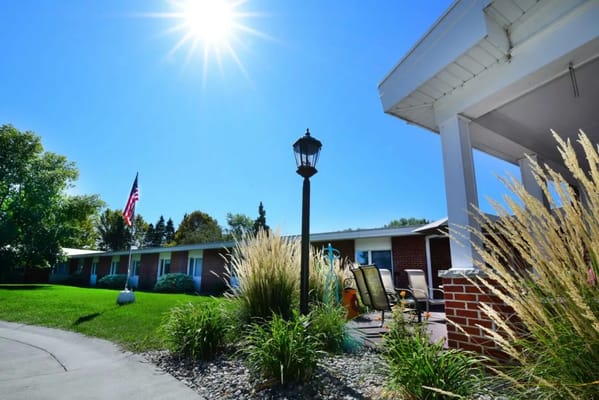 Exterior view of Valley Senior Living with flag and landscaping