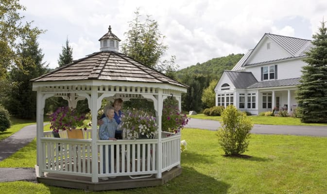 Residents enjoying flowers in a gazebo at Valley Terrace